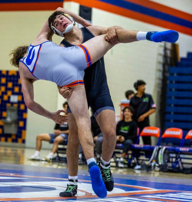 SLAM's Santiago Cabrera, front, works to upend Bishop Gorman's William Mueller during their 175 ...