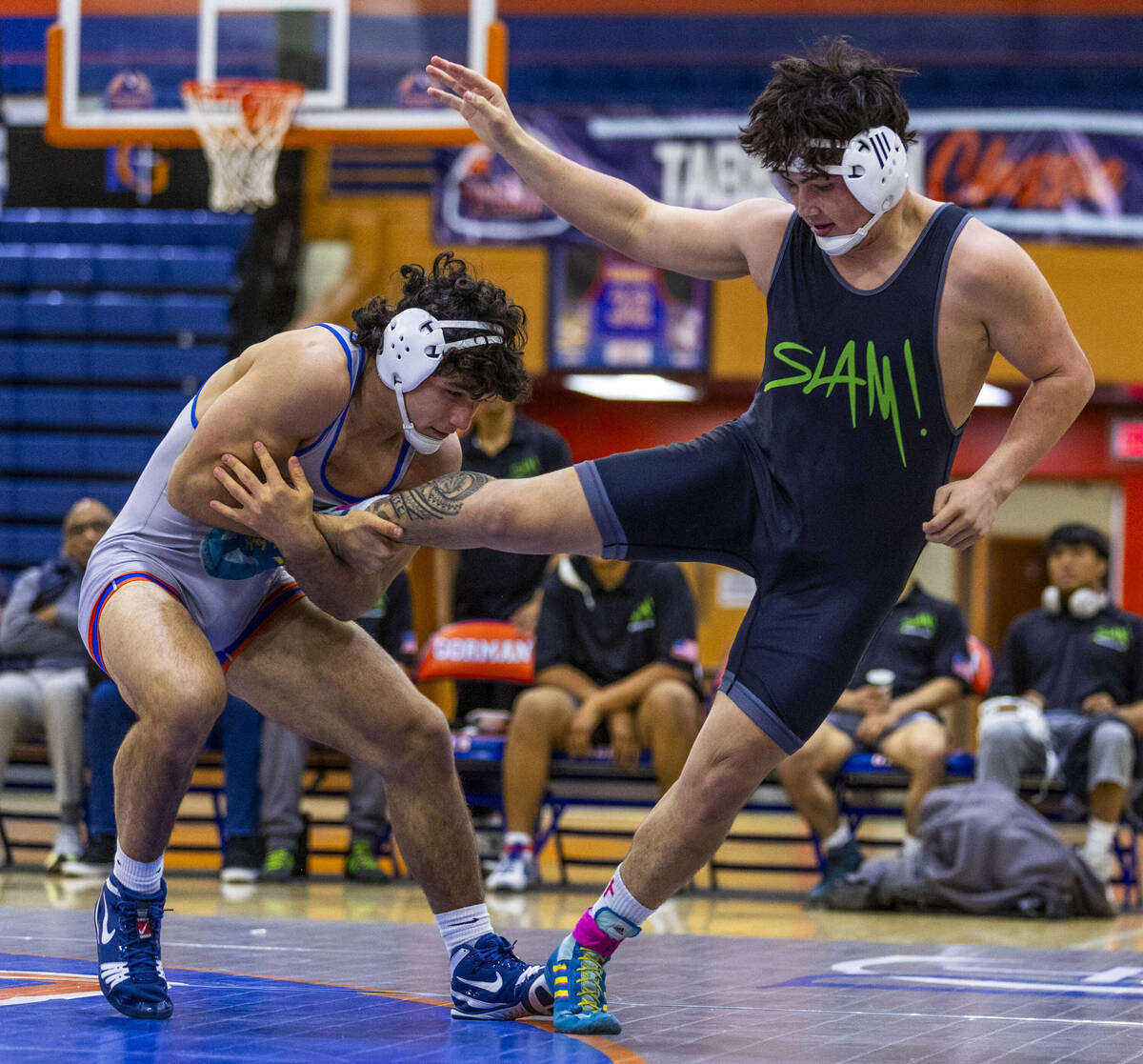 Bishop Gorman's Kage Mir, left, takes control of a leg of SLAM's Satoshi Davis during their 190 ...