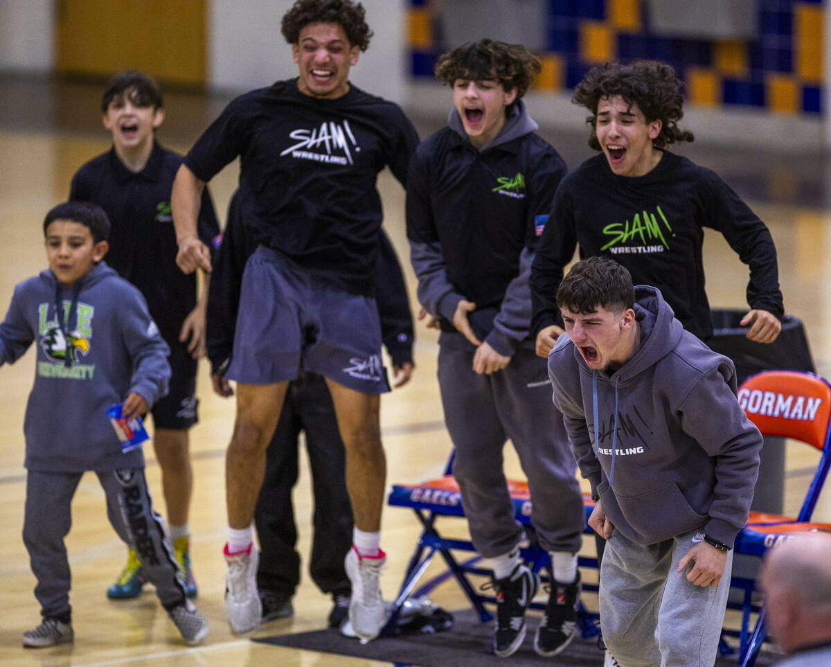 SLAM wrestlers cheer on their teammate as they battle Bishop Gorman during their NIAA wrestlin ...