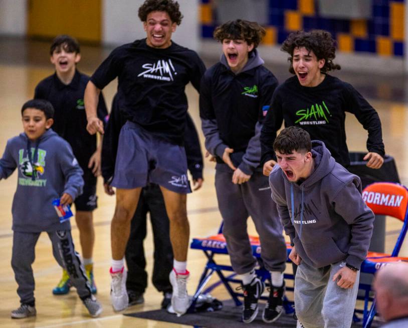 SLAM wrestlers cheer on their teammate as they battle Bishop Gorman during their NIAA wrestlin ...