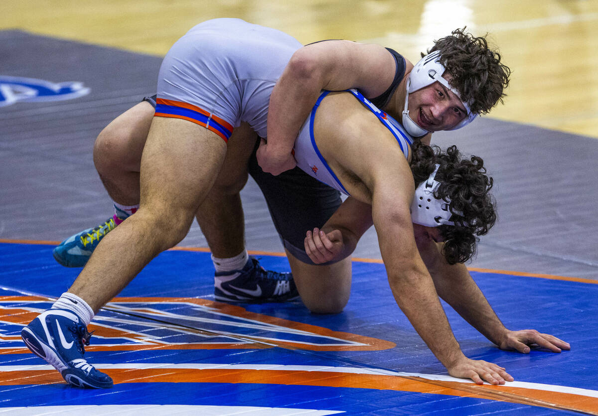 SLAM's Satoshi Davis, top, smiles as he controls Bishop Gorman's Kage Mir near the end of their ...