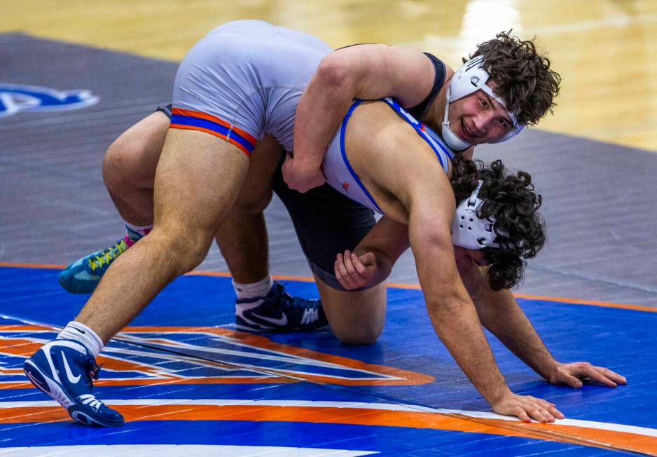 SLAM's Satoshi Davis, top, smiles as he controls Bishop Gorman's Kage Mir near the end of their ...