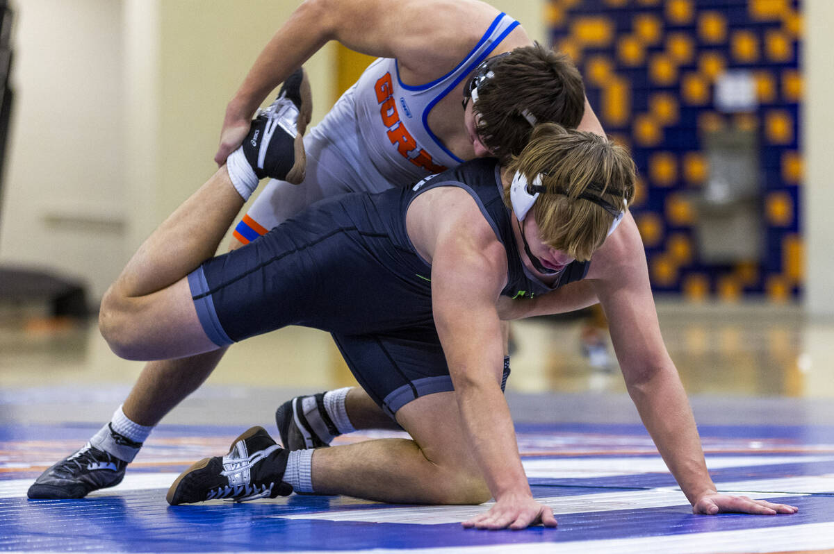 Bishop Gorman's Christian Kirkpatrick, top, works to take down SLAM's Dylan Tondreau during the ...