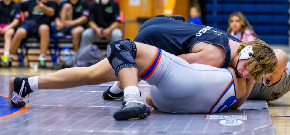 SLAM's Dylan Tondreau, top, is close to a pin on Bishop Gorman's Christian Kirkpatrick during t ...