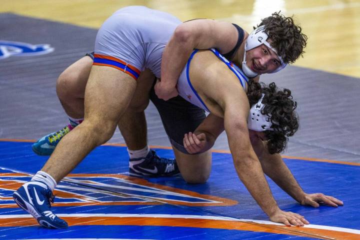 SLAM's Satoshi Davis, top, smiles as he controls Bishop Gorman's Kage Mir near the end of their ...