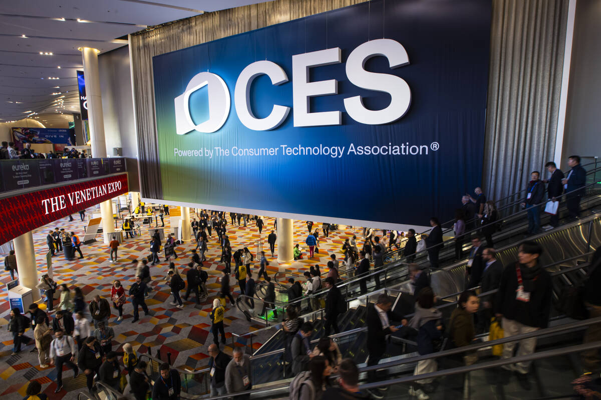 CES attendees take the escalator at The Venetian Expo on Tuesday, Jan. 7, 2025, in Las Vegas. ( ...