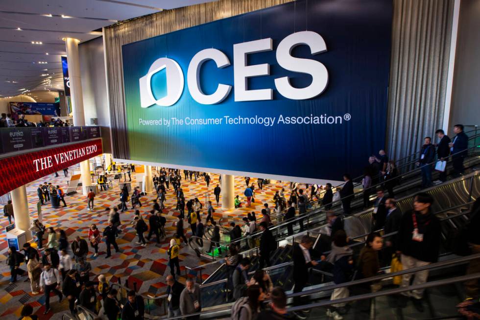 CES attendees take the escalator at The Venetian Expo on Tuesday, Jan. 7, 2025, in Las Vegas. ( ...