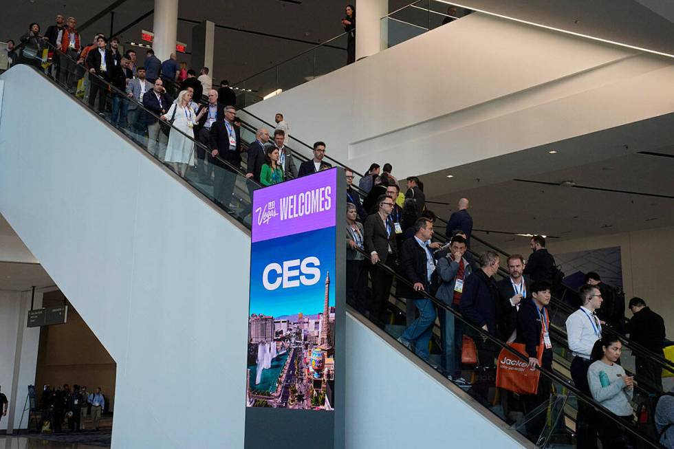 Crowds ride an escalator during the CES tech show, Tuesday, Jan. 7, 2025, in Las Vegas. (AP Pho ...