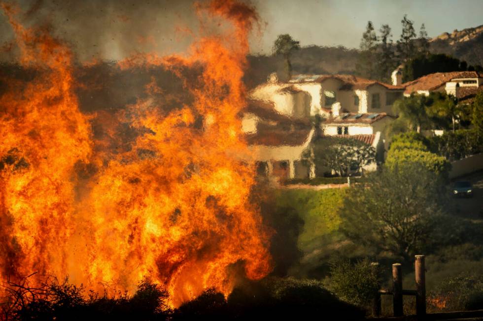 Flames rise as the Palisades Fire advances on homes in the Pacific Palisades neighborhood of Lo ...