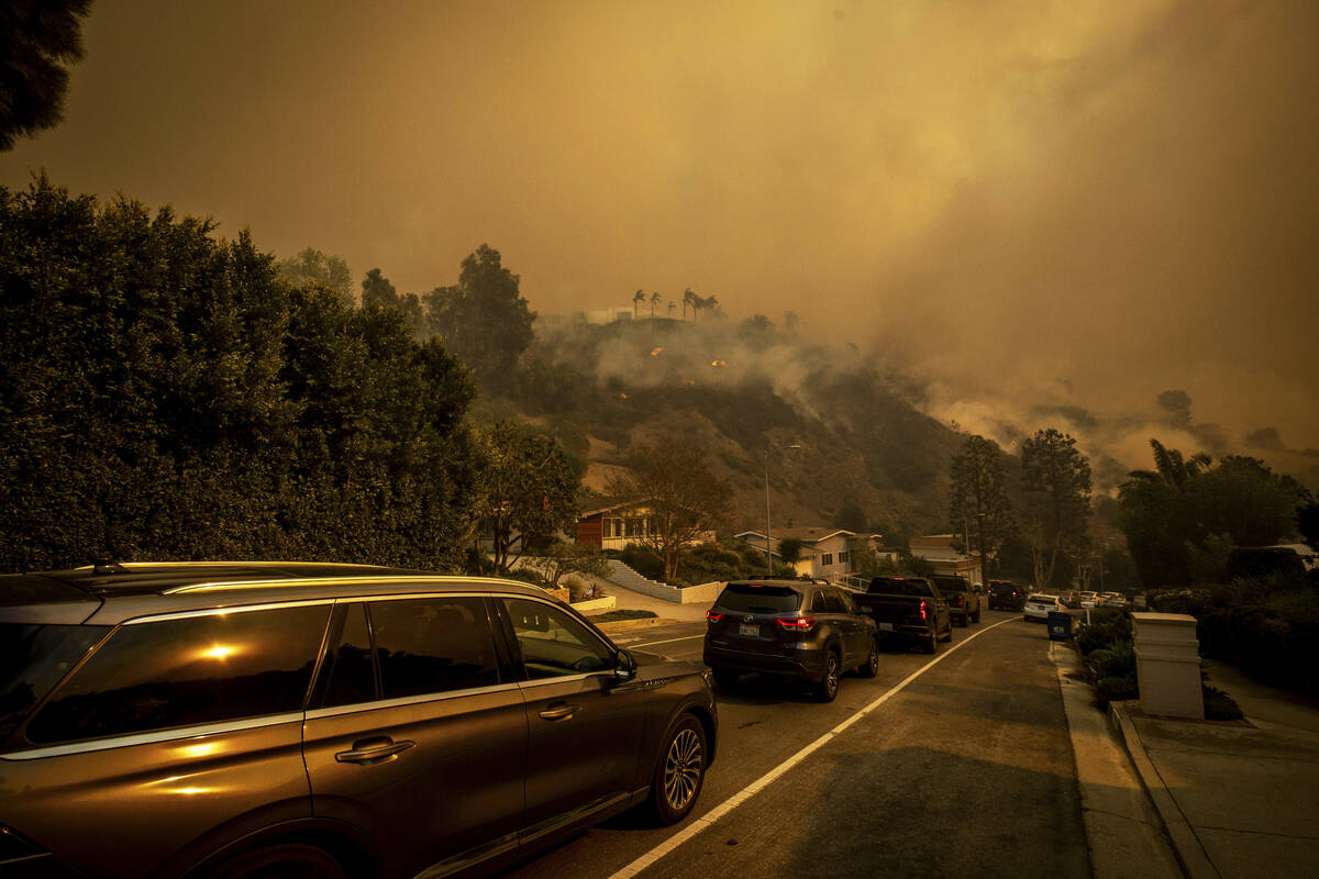 A line of vehicles crowds the road as residents flee from the Palisades Fire in the Pacific Pal ...