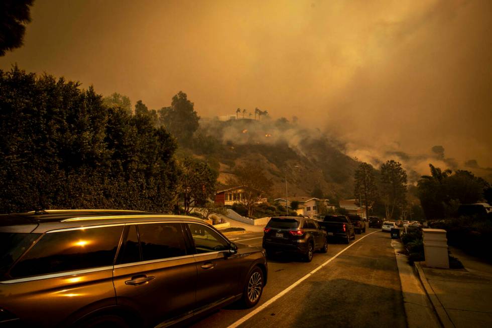 A line of vehicles crowds the road as residents flee from the Palisades Fire in the Pacific Pal ...