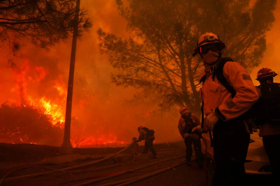 Firefighters battle the advancing Palisades Fire in the Pacific Palisades neighborhood of Los A ...