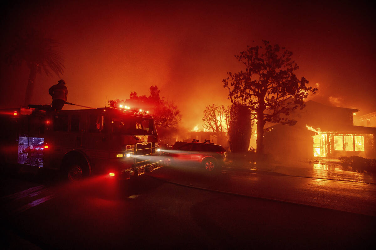 Fire crews battle the Palisades Fire as it burns multiple structures in the Pacific Palisades n ...