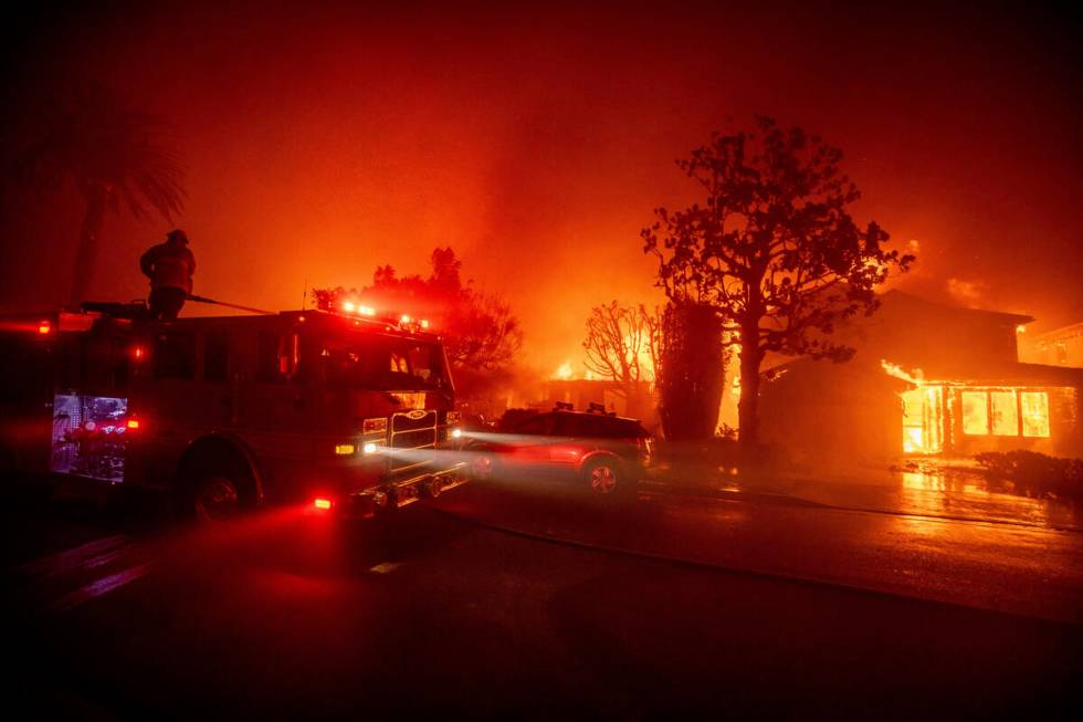 Fire crews battle the Palisades Fire as it burns multiple structures in the Pacific Palisades n ...