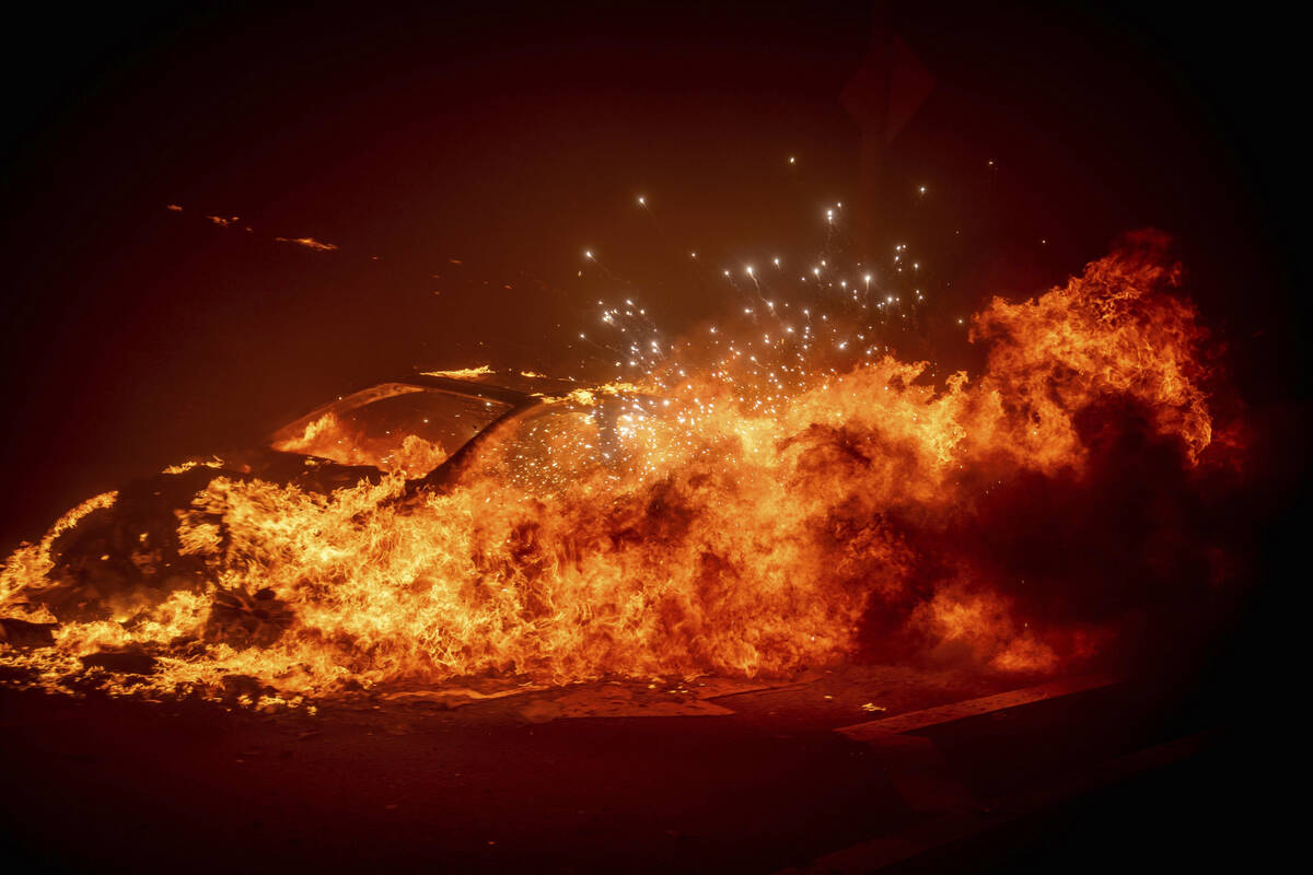 A vehicle burns as the Palisades Fire advances in the Pacific Palisades neighborhood of Los Ang ...