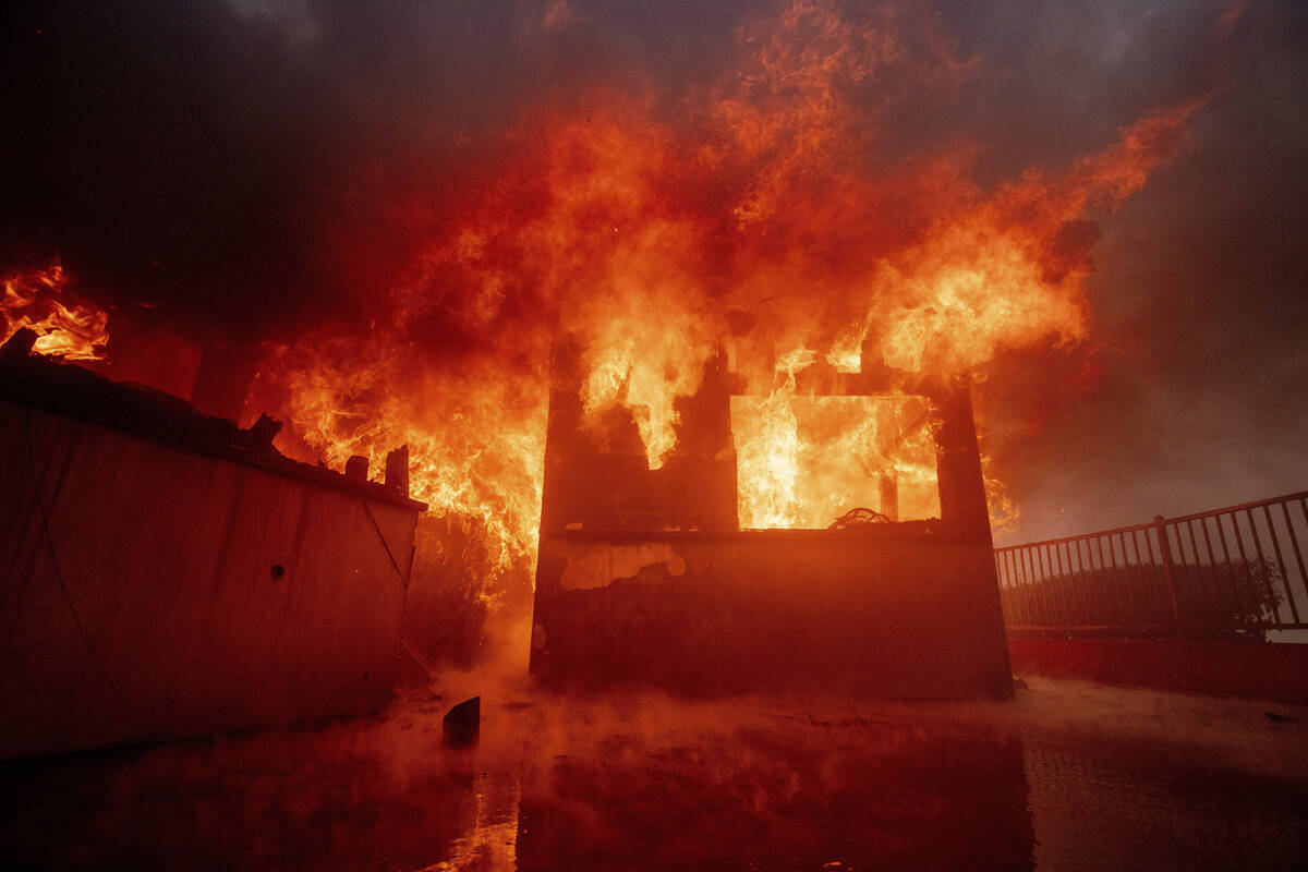 The Palisades Fire burns a property in the Pacific Palisades neighborhood of Los Angeles, Tuesd ...