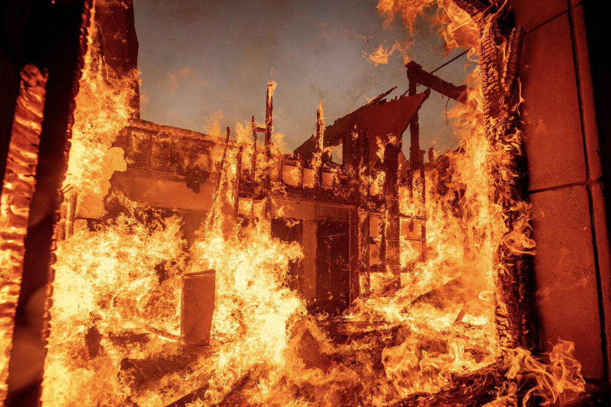 The Palisades Fire burns a residence in the Pacific Palisades neighborhood of Los Angeles, Tues ...