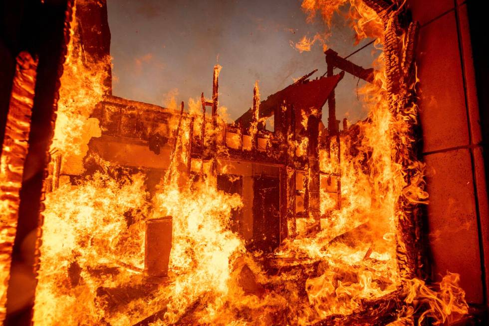 The Palisades Fire burns a residence in the Pacific Palisades neighborhood of Los Angeles, Tues ...