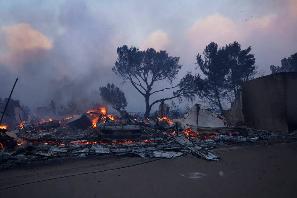 A fire-ravaged property smolder after the Palisades Fire swept through in the Pacific Palisades ...