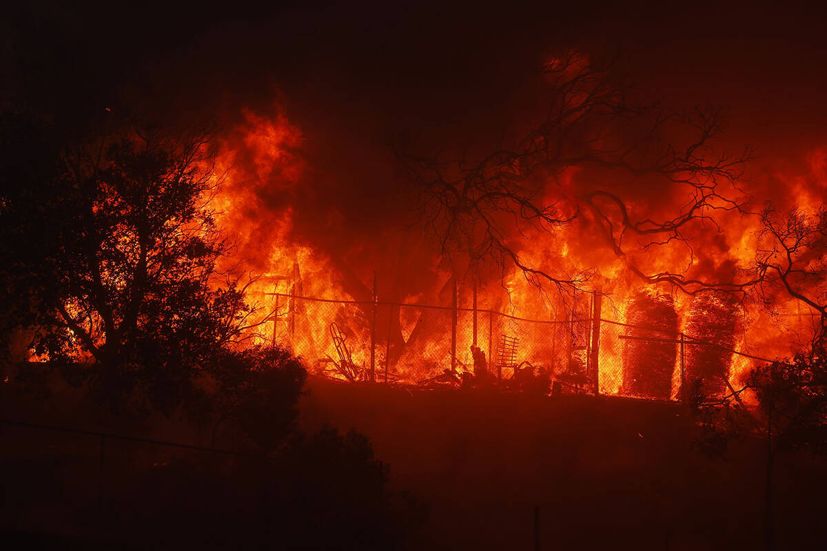 The Palisades Fire burns a property in the Pacific Palisades neighborhood of Los Angeles, Tuesd ...