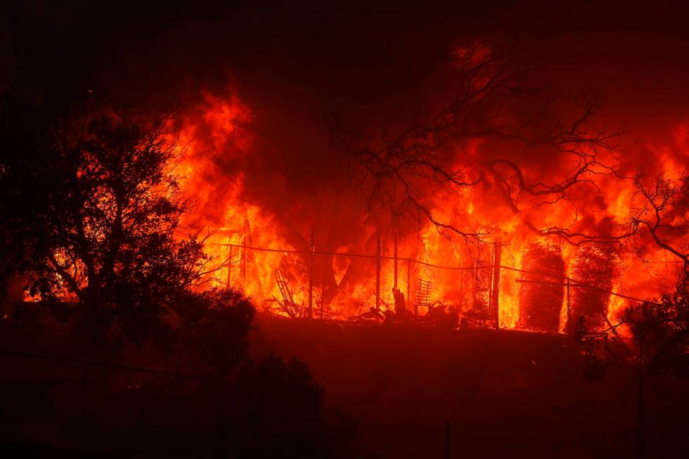 The Palisades Fire burns a property in the Pacific Palisades neighborhood of Los Angeles, Tuesd ...