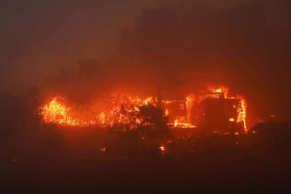 The Palisades Fire burns a property in the Pacific Palisades neighborhood of Los Angeles, Tuesd ...