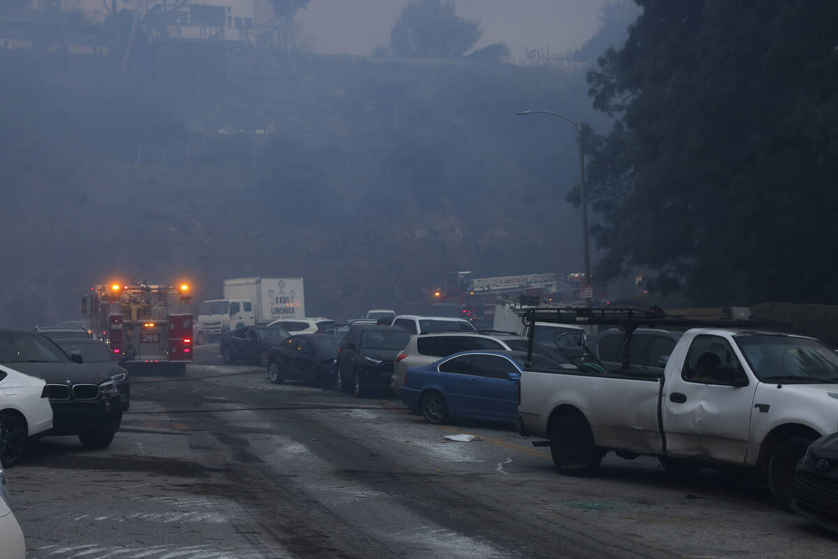 Vehicles are left stranded off the side of the road after residents tried to flee from the Pali ...