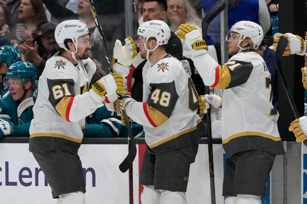 Vegas Golden Knights right wing Mark Stone (61) is congratulated by center Tomas Hertl (48) and ...