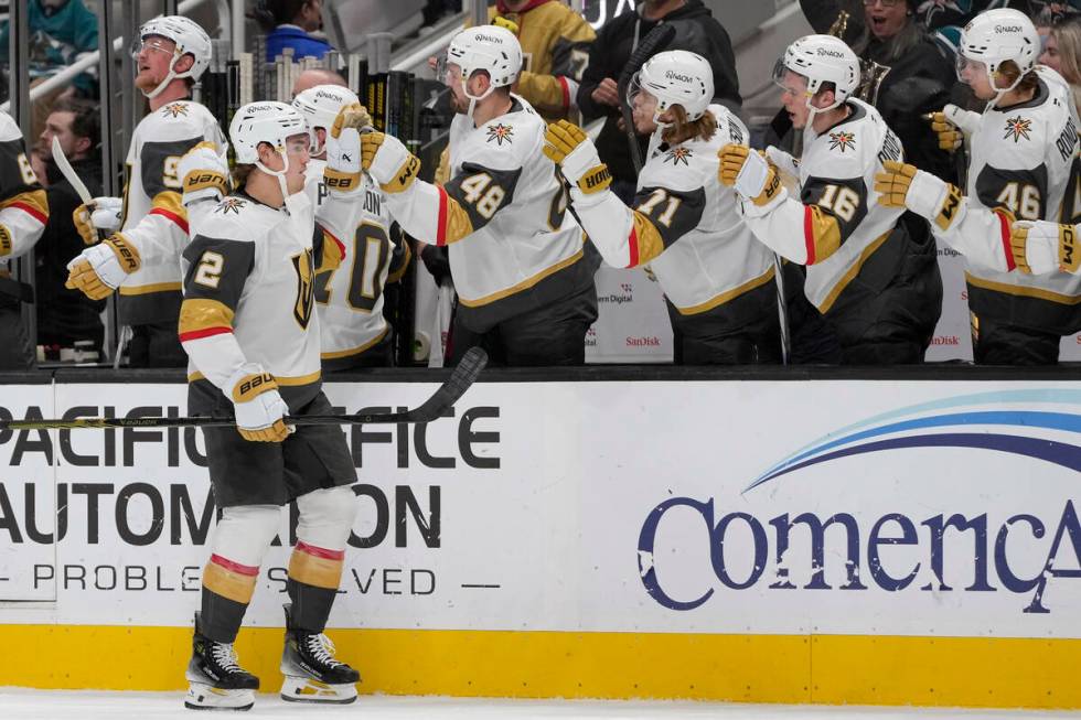 Vegas Golden Knights defenseman Zach Whitecloud (2) is congratulated by teammates after scoring ...