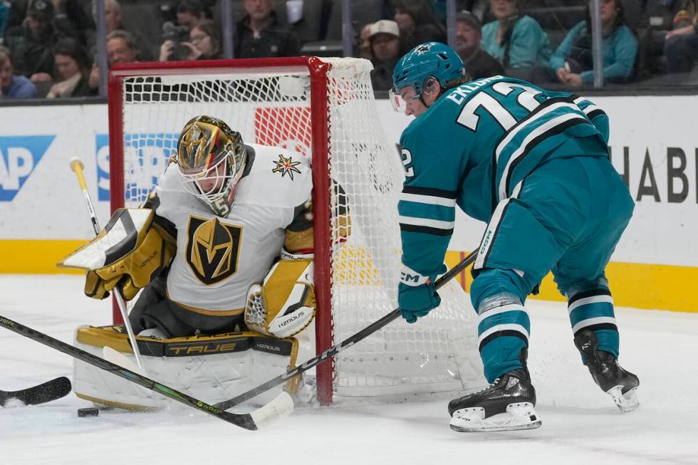 Vegas Golden Knights goaltender Ilya Samsonov, left, defends against a shot by San Jose Sharks ...