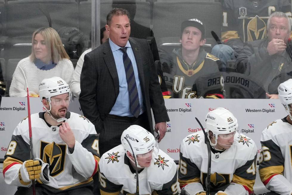 Vegas Golden Knights head coach Bruce Cassidy, standing, reacts from behind players on the benc ...