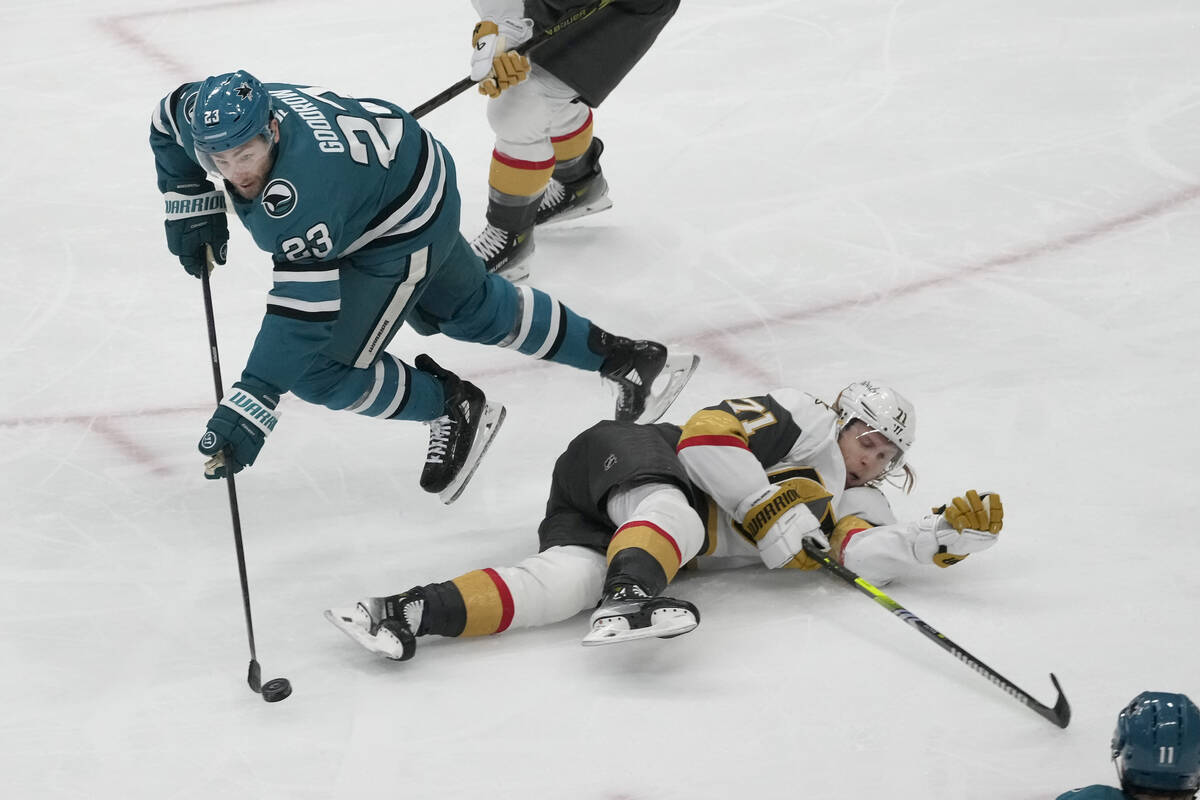 San Jose Sharks right wing Barclay Goodrow, left, reaches for the puck over Vegas Golden Knight ...