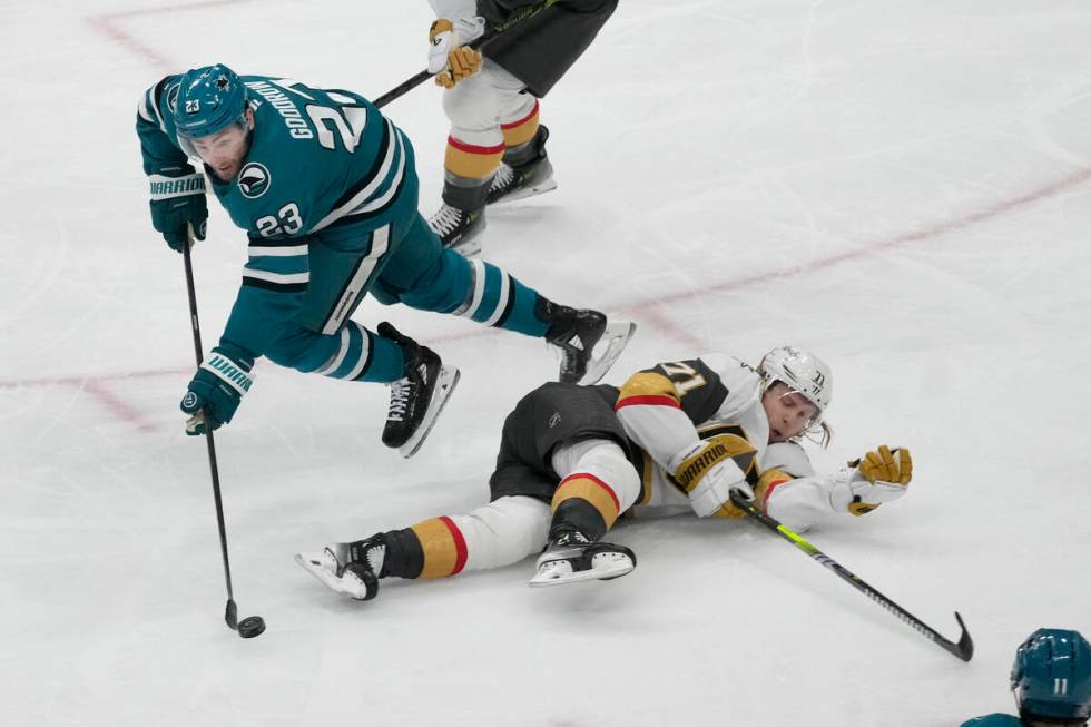 San Jose Sharks right wing Barclay Goodrow, left, reaches for the puck over Vegas Golden Knight ...