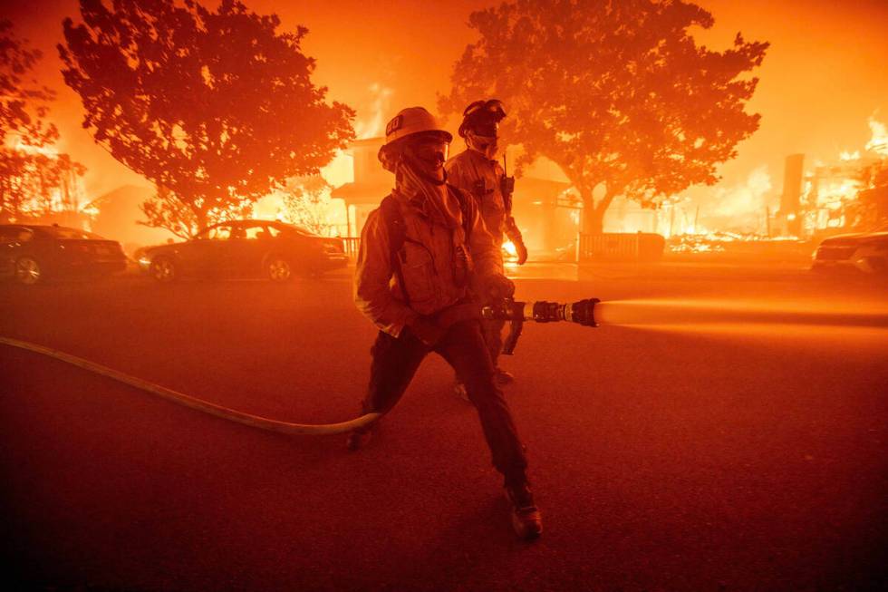 Firefighters battle the Palisades Fire as it burns multiple structures in the Pacific Palisades ...