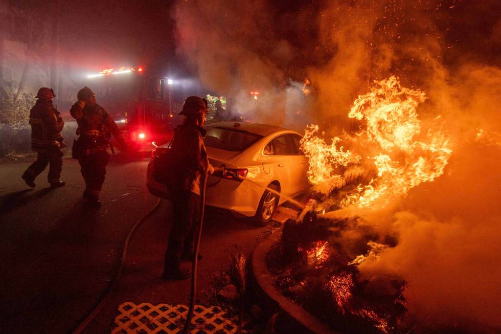 Firefighters battle the Eaton Fire Tuesday, Jan. 7, 2025 in Altadena, Calif. (AP Photo/Ethan Swope)