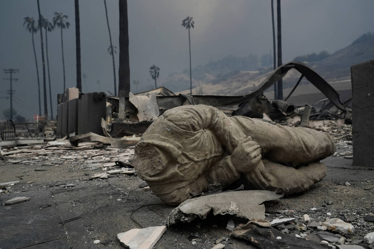 A statue and other structures are burned as the Palisades Fire ravages a neighborhood amid high ...