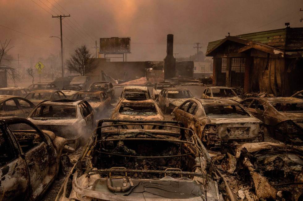 Fire-damaged vehicles are lined up at a dealership after the Eaton Fire swept through Wednesday ...