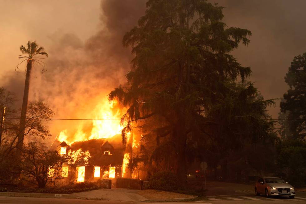 A house on Santa Rosa Ave., also known as Christmas Tree Lane, is engulfed in flames, Wednesday ...