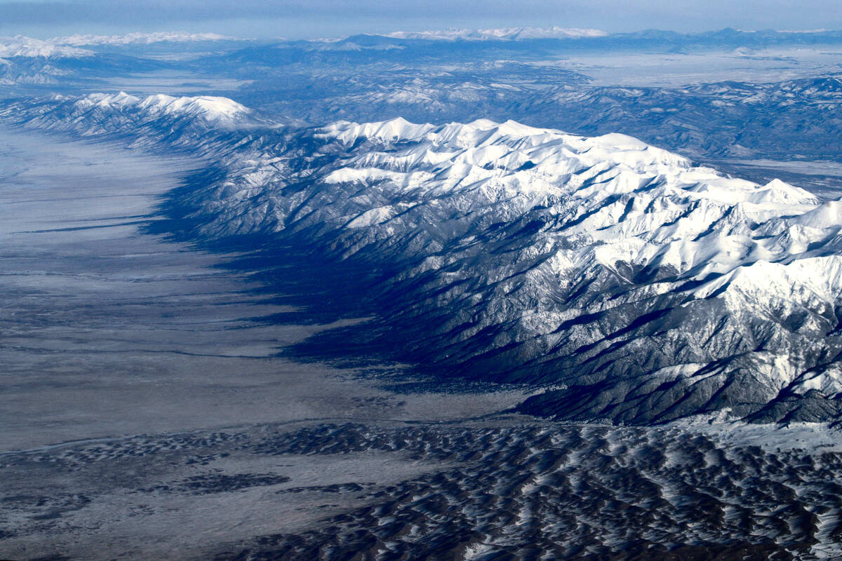 Covered with freshly fallen snow, the Rocky Mountains rise above central Colorado on Dec. 17, 2 ...