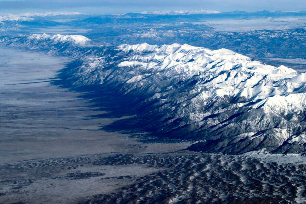 Covered with freshly fallen snow, the Rocky Mountains rise above central Colorado on Dec. 17, 2 ...