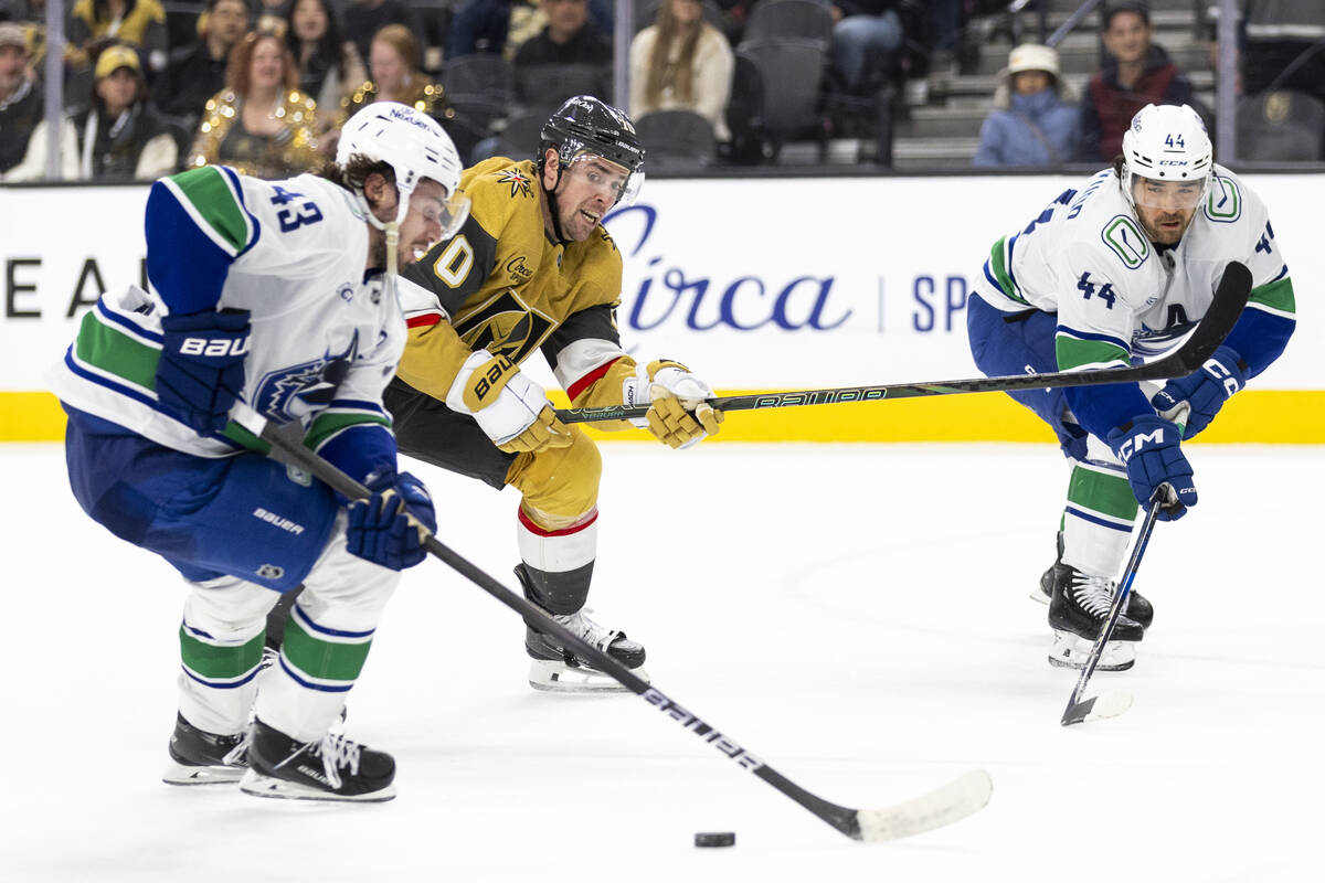 Vancouver Canucks defenseman Quinn Hughes (43), Golden Knights left wing Tanner Pearson (70) an ...