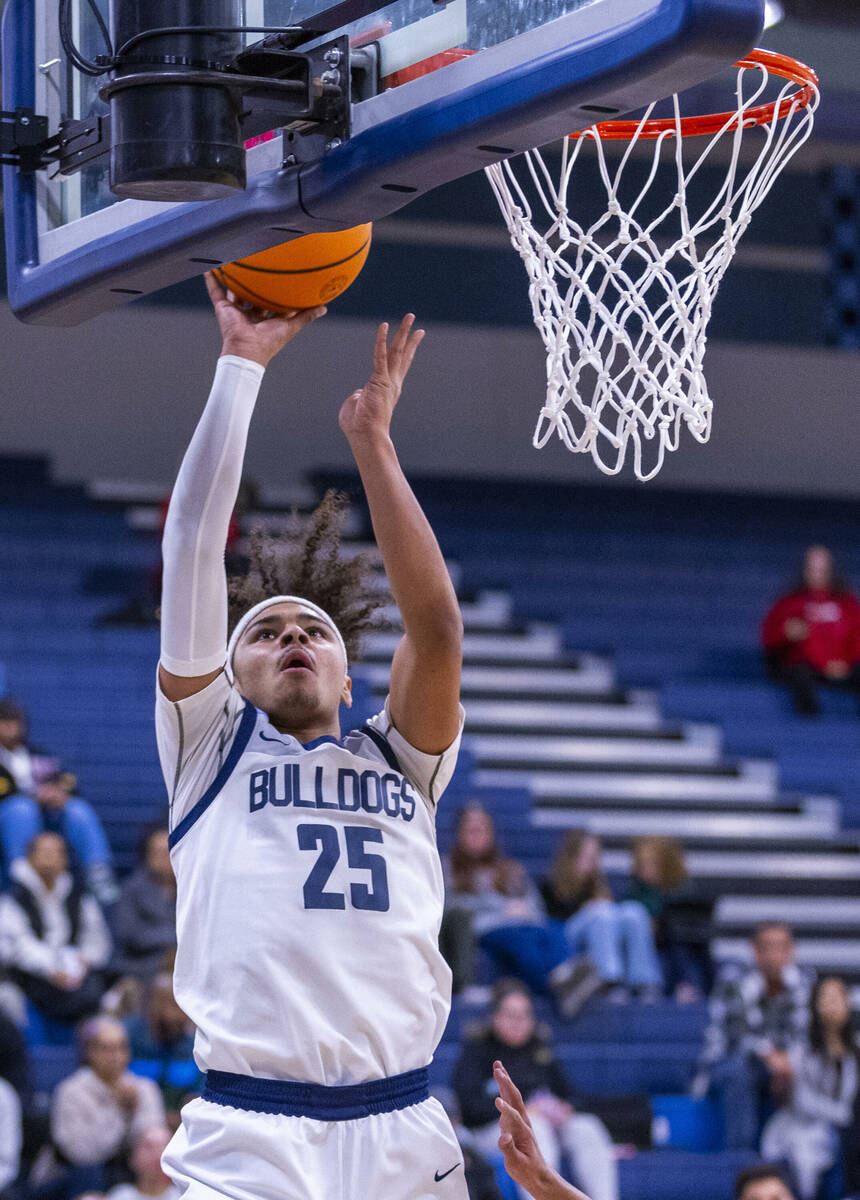 Centennial's Jayonni Durrough (25) scores over Liberty's defense during the first half of their ...