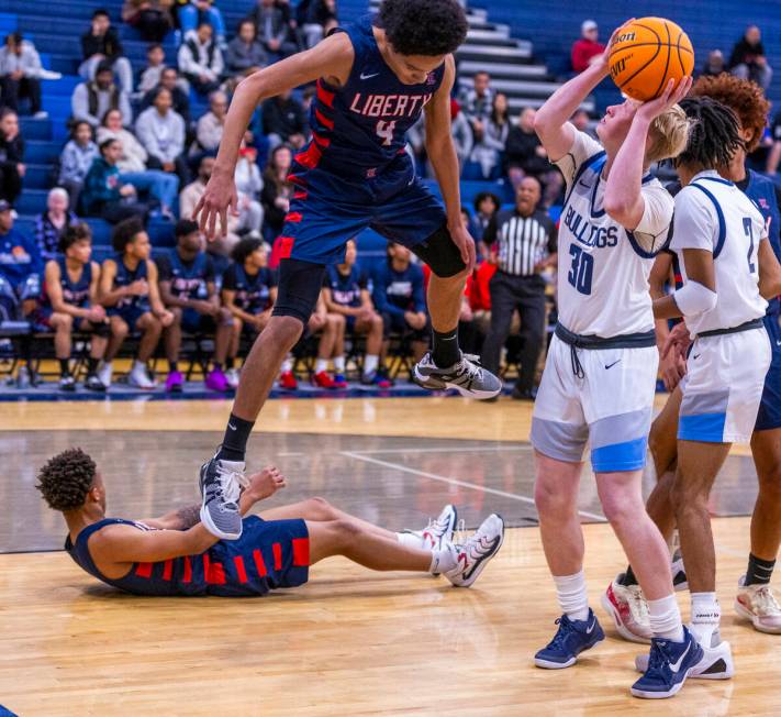 Centennial's Cooper Jenkins (30) secures a rebound against Liberty's Jaden Riley (13) and Taytu ...