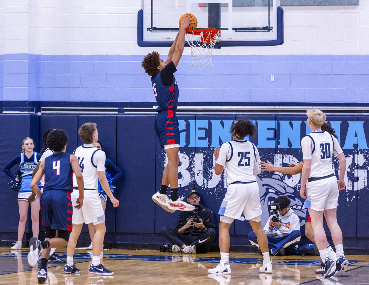 Liberty's Dante Steward (5) dunks the ball as Centennial's Jayonni Durrough (25) looks on durin ...