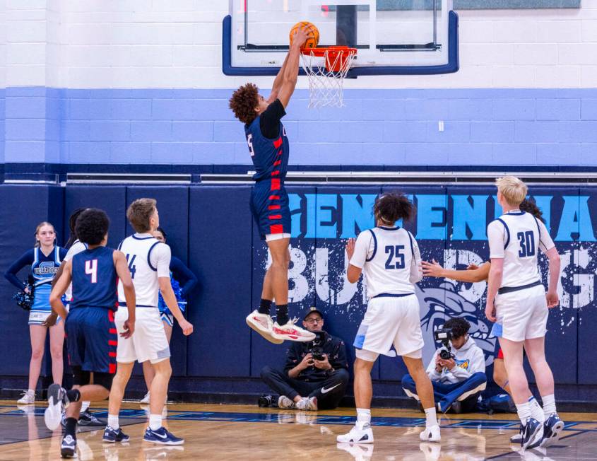 Liberty's Dante Steward (5) dunks the ball as Centennial's Jayonni Durrough (25) looks on durin ...