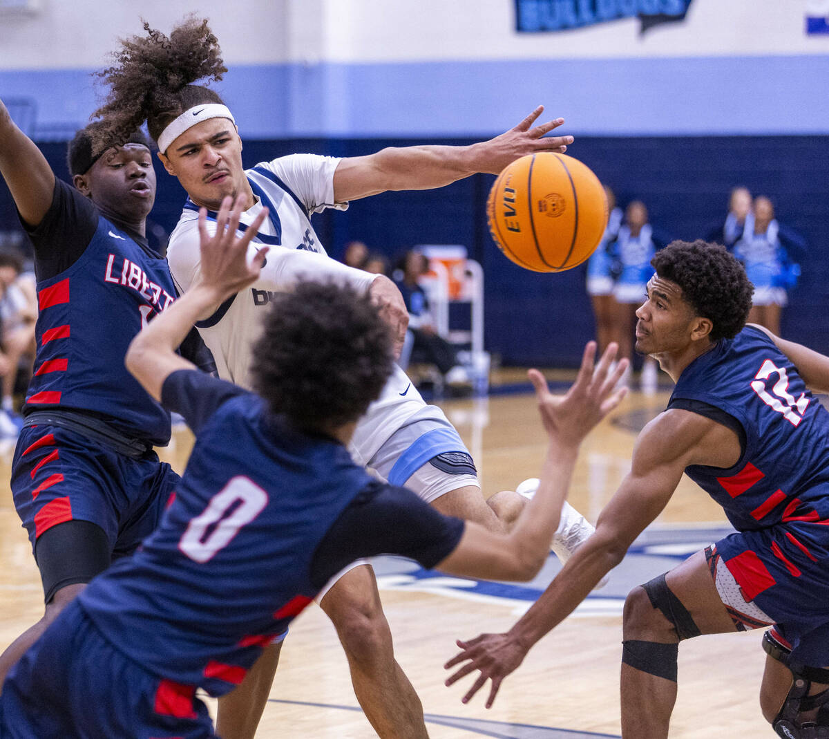 Centennial's Jayonni Durrough (25) gets off a pass against Liberty's Evan Hilliard (12) and tea ...