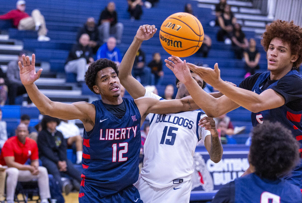 Liberty's Evan Hilliard (12) and Centennial's Jaden Dudley (15) look on as Liberty's Dante Stew ...