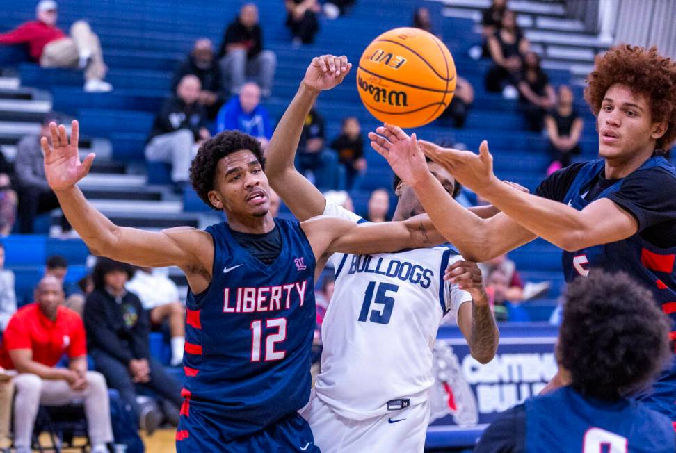 Liberty's Evan Hilliard (12) and Centennial's Jaden Dudley (15) look on as Liberty's Dante Stew ...