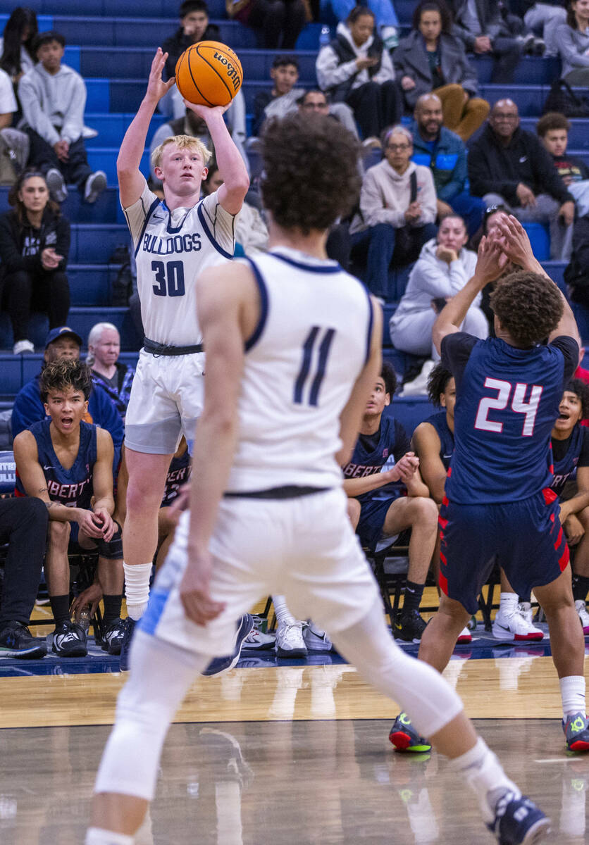 Centennial's Cooper Jenkins (30) gets off a shot over Liberty's Kobe Kelley (24) during the fir ...