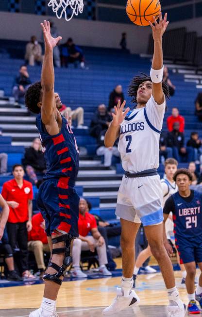 Liberty's Evan Hilliard (12) defends as Centennial's Zyon Harris (2) gets off a shot during the ...